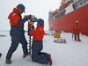 John Kemp (standing) with Kris Newhall prepare to drill a hole in the ice in the Beaufort Sea